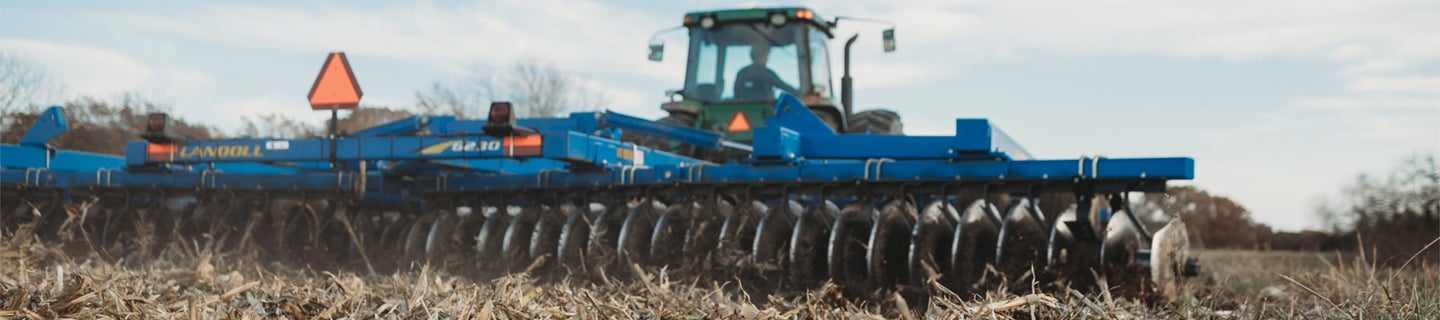 Tractor disking a field.
