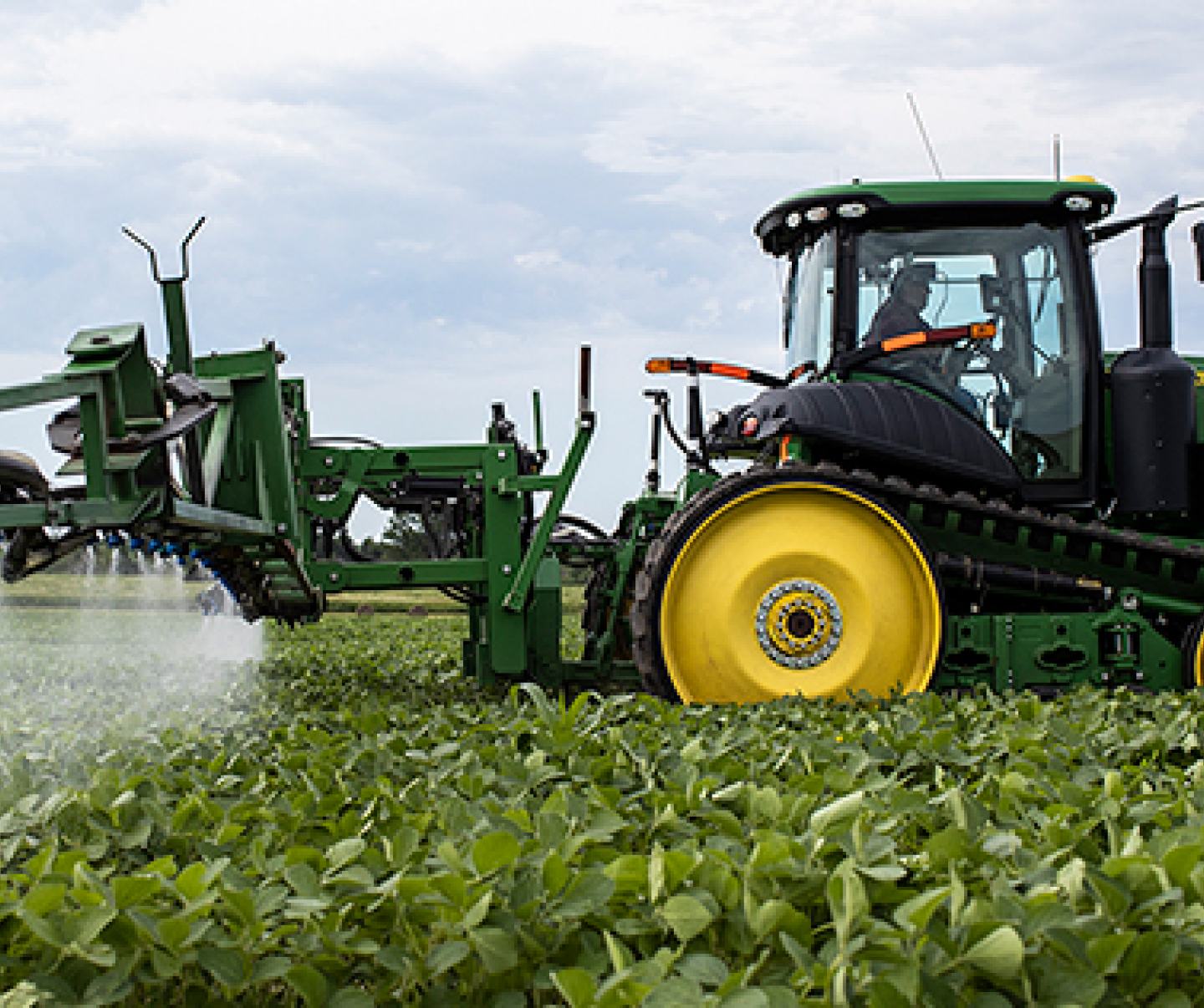 Tractor spraying crops